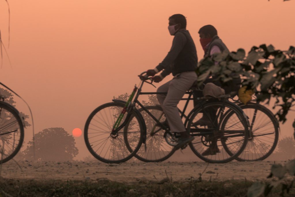 Two men ride bicycles on the road to the Gadhimai in Nepal