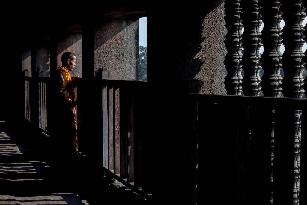 A Buddhist monk looks out over the landscape in Cambodia