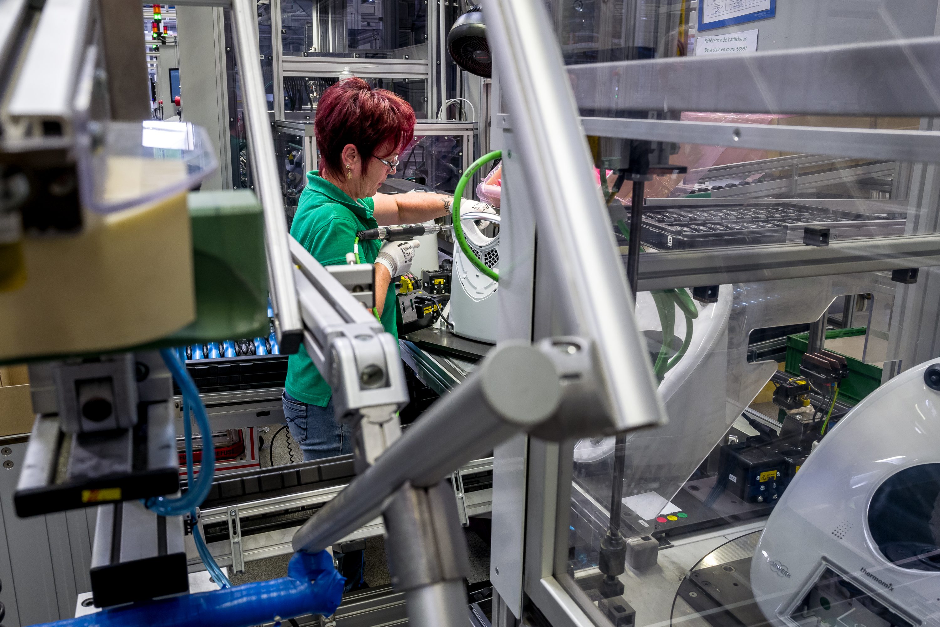 An employee assembles part of a Thermomix in France