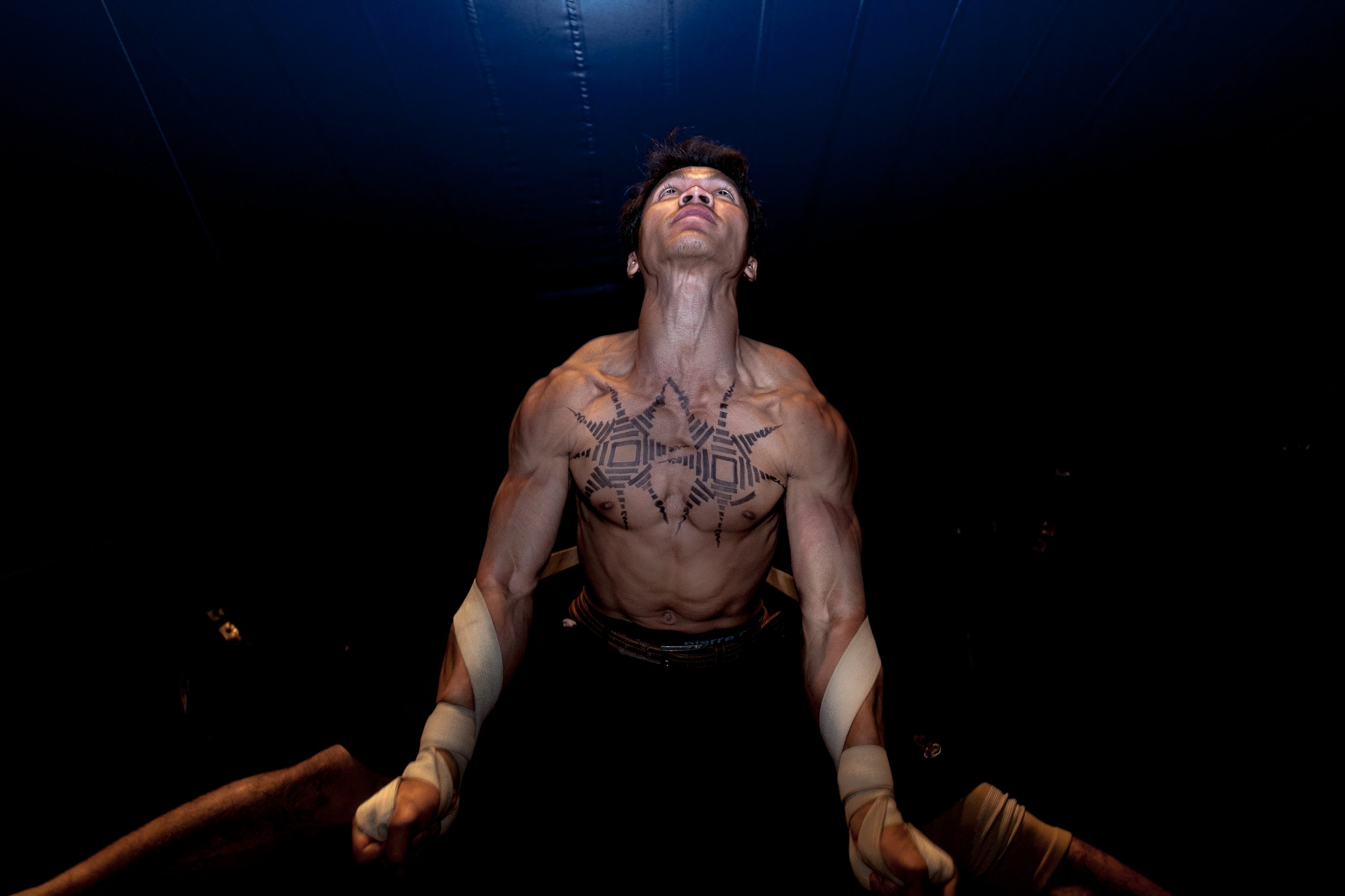 An artist of the Phare Ponleu Selpak circus performs acrobatics on a vertical hanging rope in Cambodia