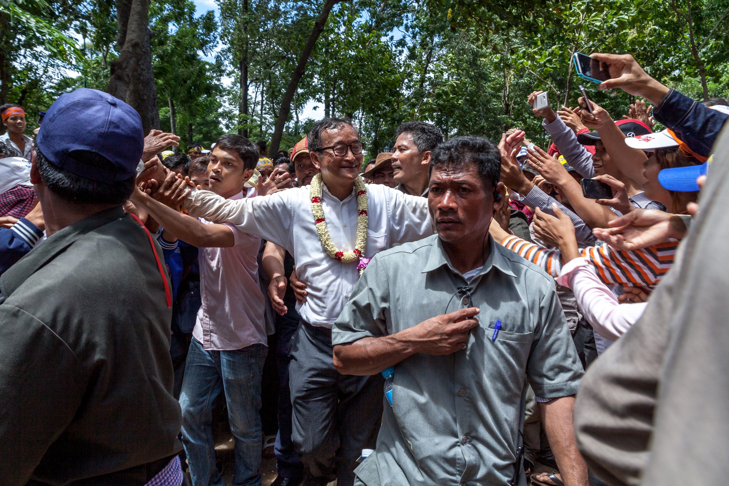 Sam Rainsy is greeted by dozens of fervent supporters in Cambodia