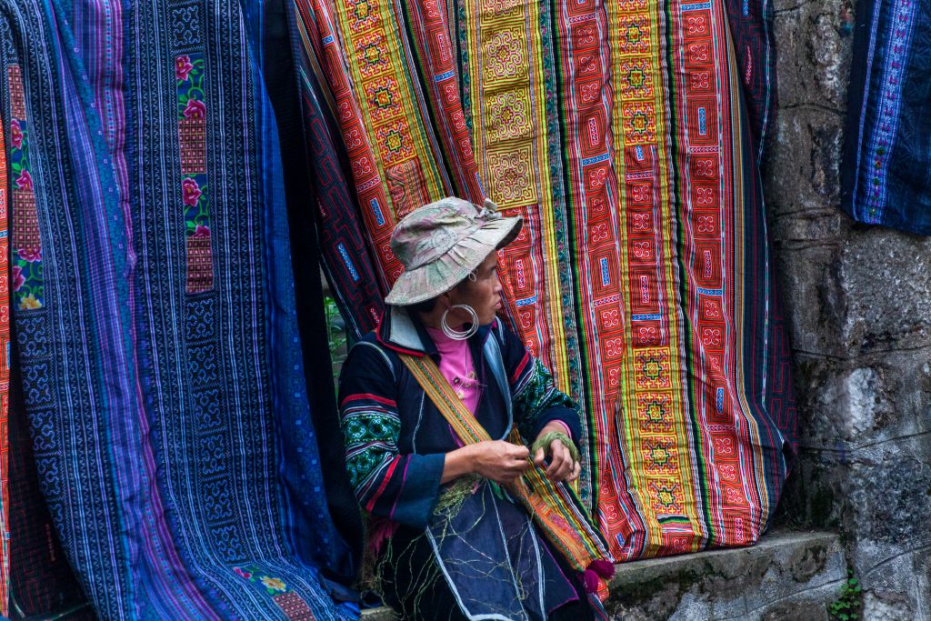 A young Hmong woman prepares hemp for sewing blankets in Vietnam