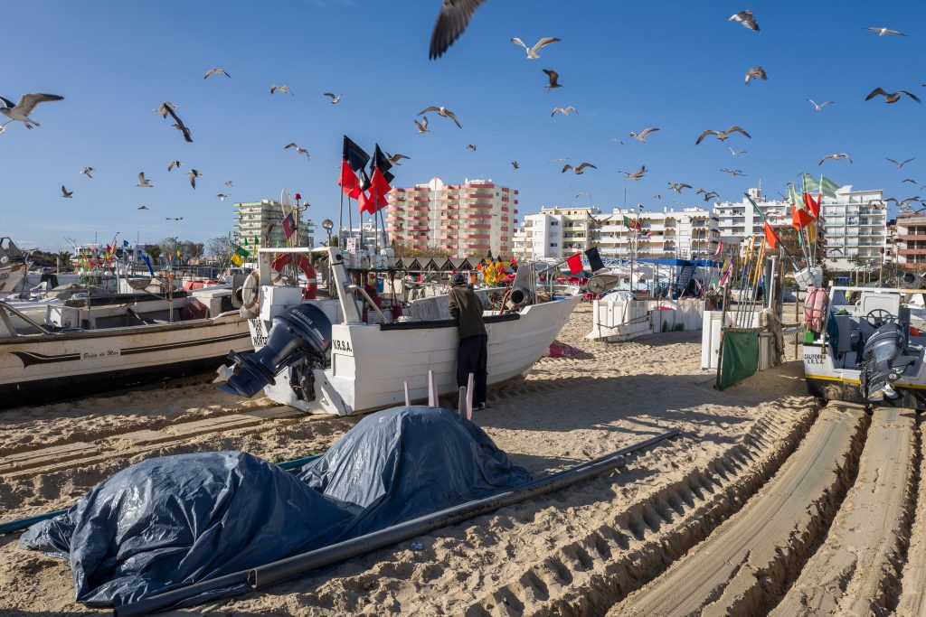 A local fisherman prepares his fishing boat in Portugal