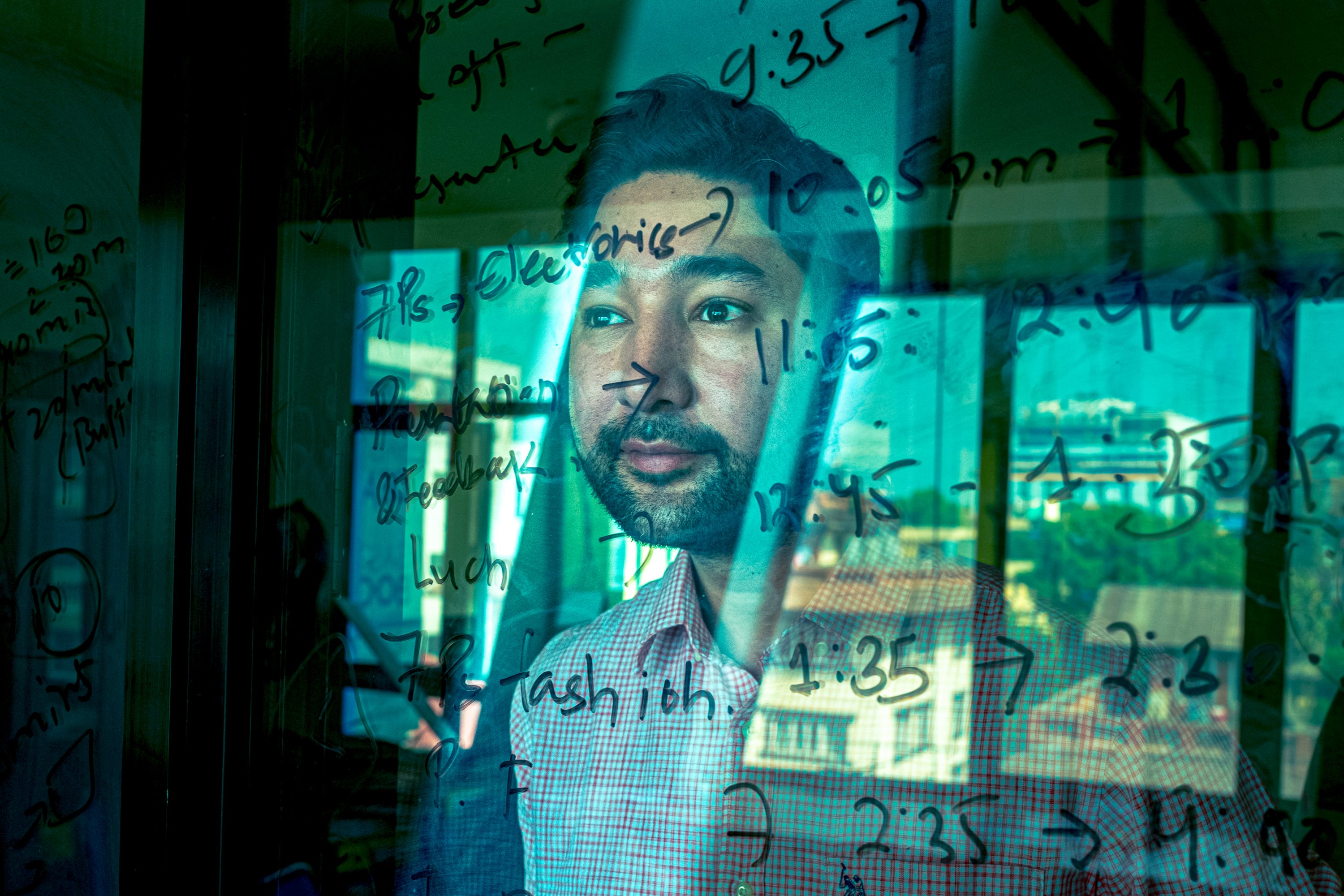 mun Thapa, Founder of Sastodeal, is seen through a window in Nepal