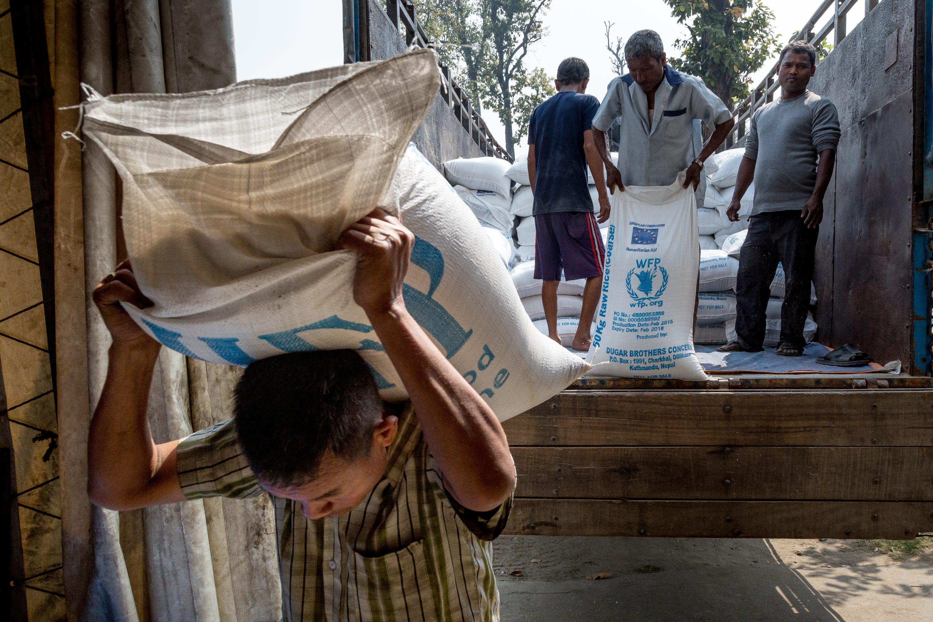 AGRICULTURE AND FOOD PORTFOLIO A worker carries a sac filled with rice inside one of the World Food Programme in Nepal