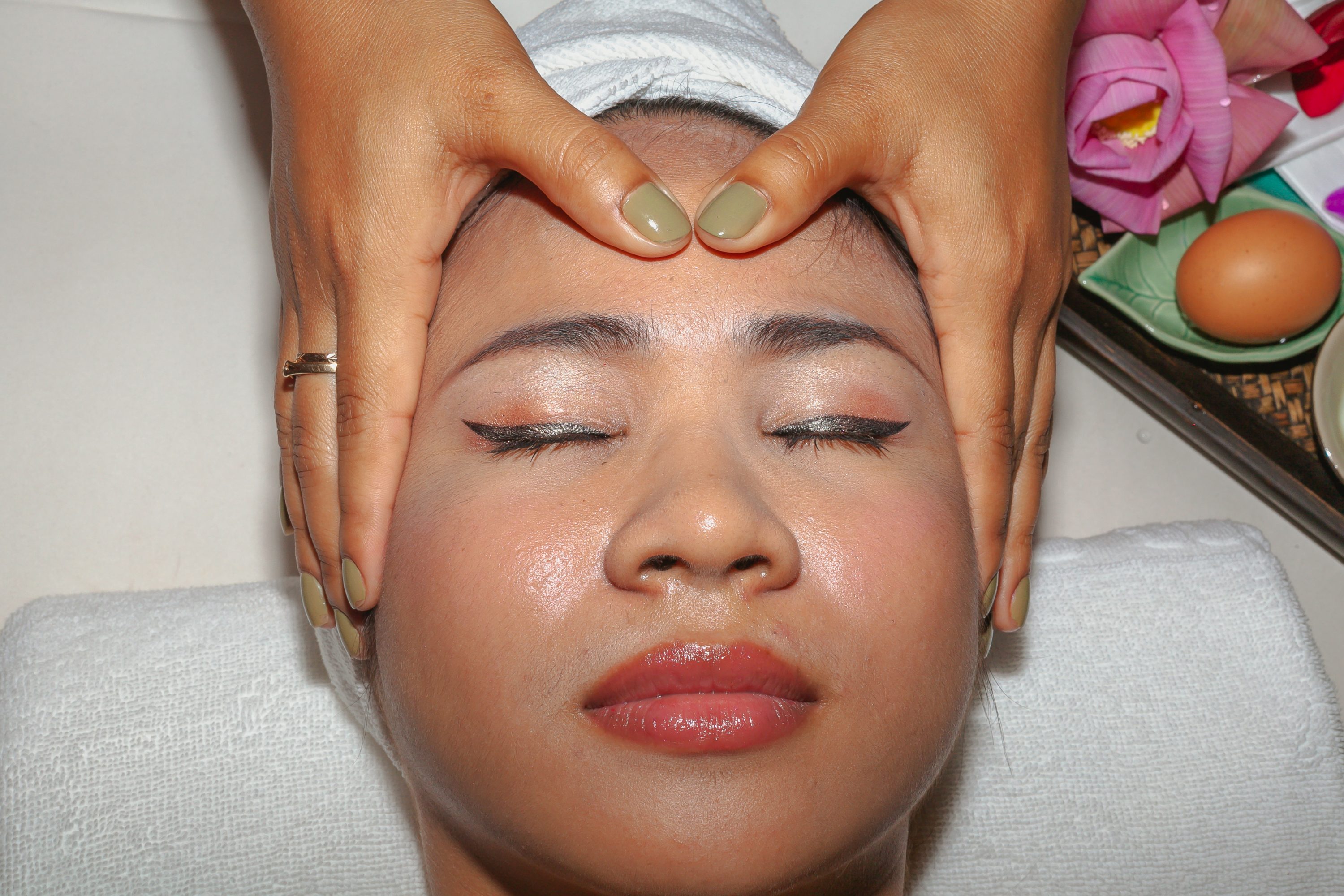 A customer receives a face massage in Cambodia