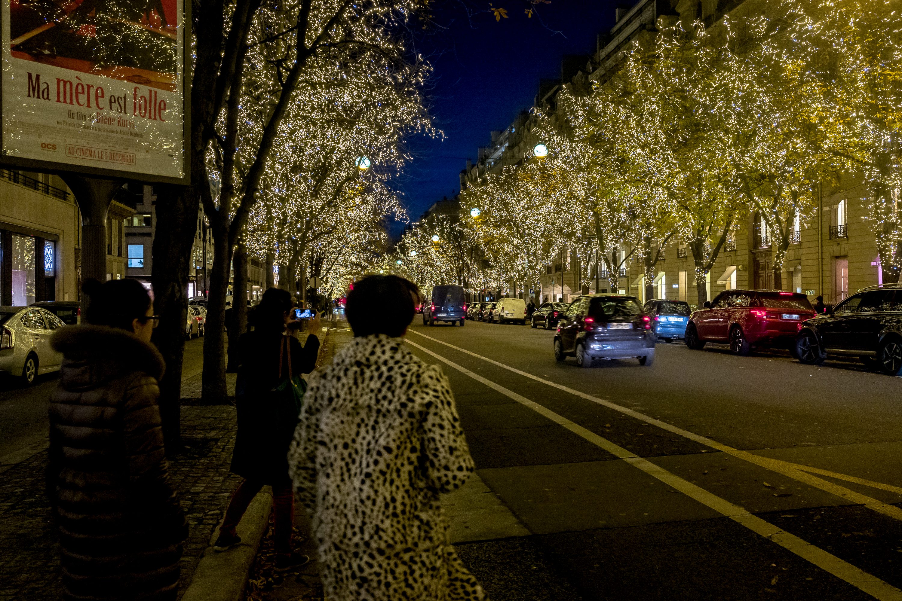 Chinese tourists walk on one of the avenues in Paris