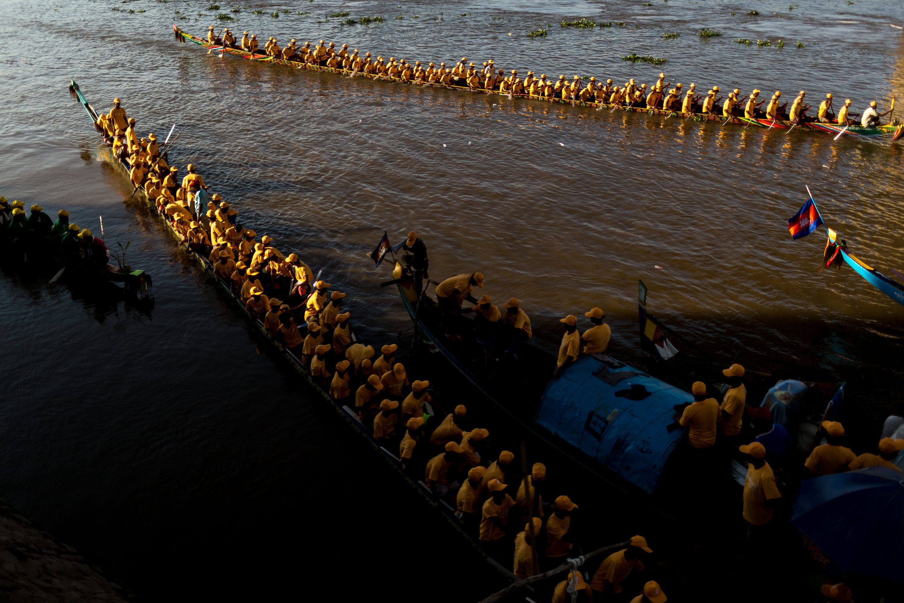 Boat crew members train on the waters of the Tonle Sap River in Cambodia