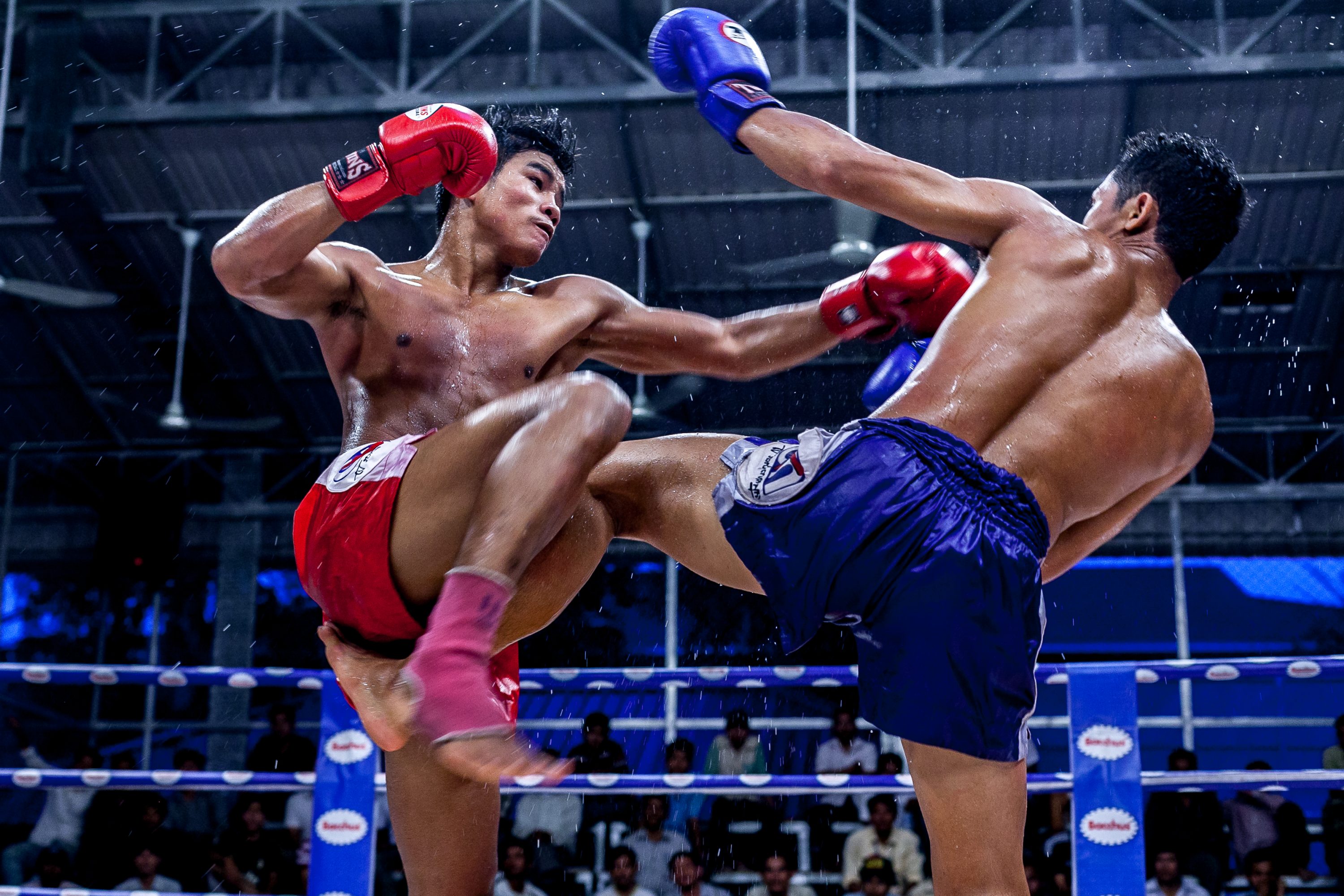 A Cambodian Kun Khmer fighter hits his opponent in Cambodia
