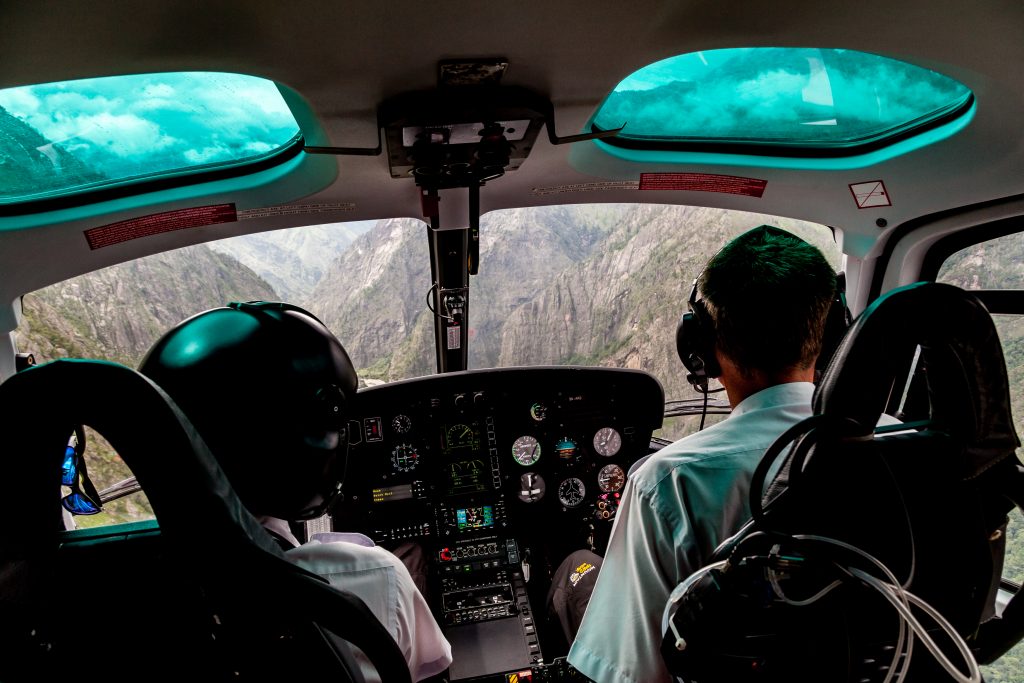 Pilots fly a helicopter in Nepal