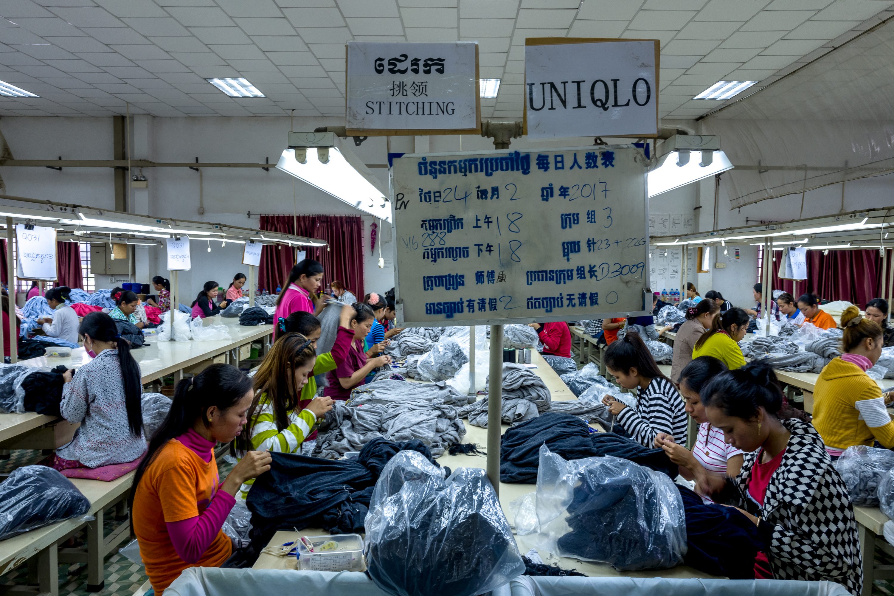 Employees of a textile factory stitch clothes in Cambodia