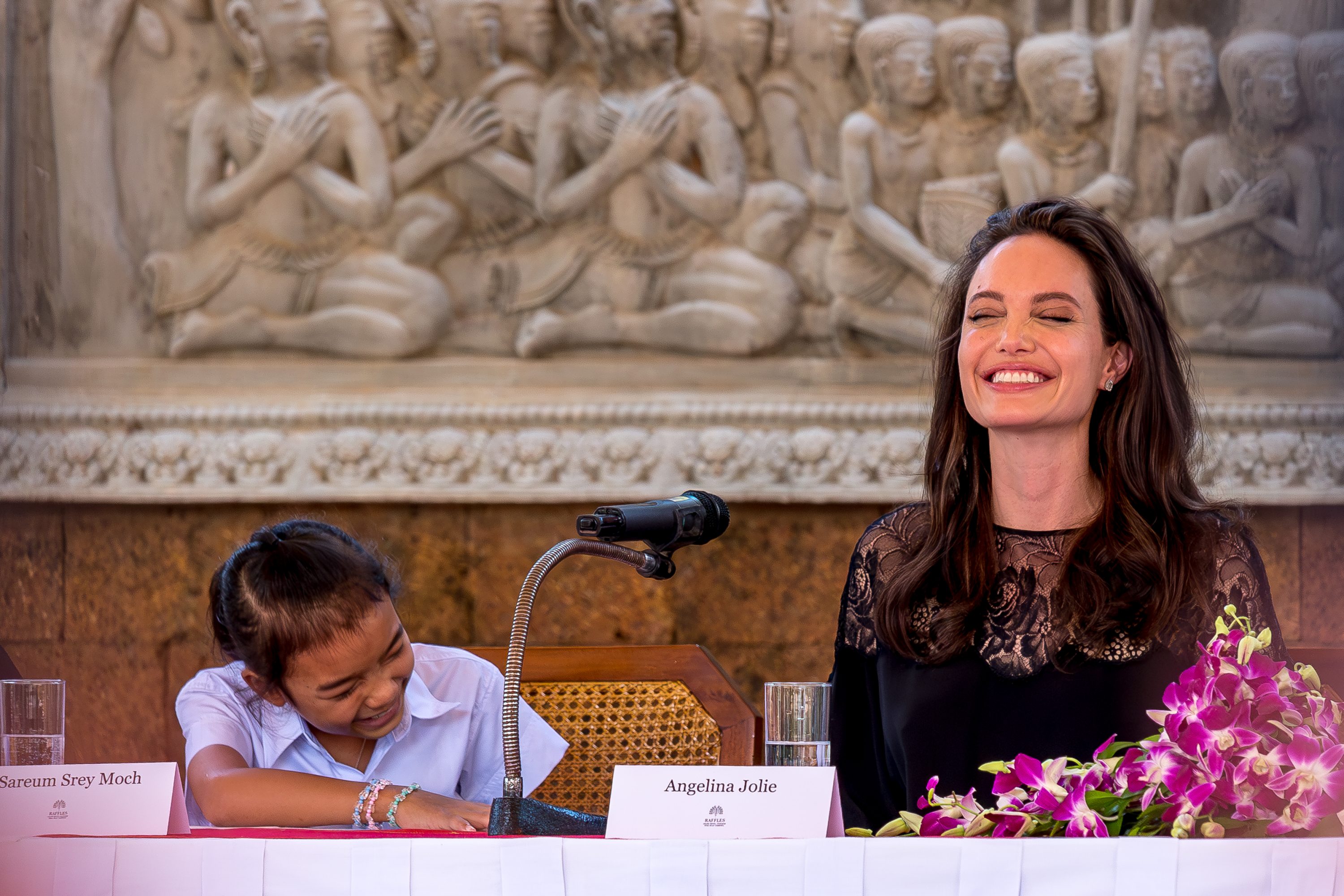 Angelina Jolie (right) laughs with actress Sareum Srey Moch (left) in Cambodia