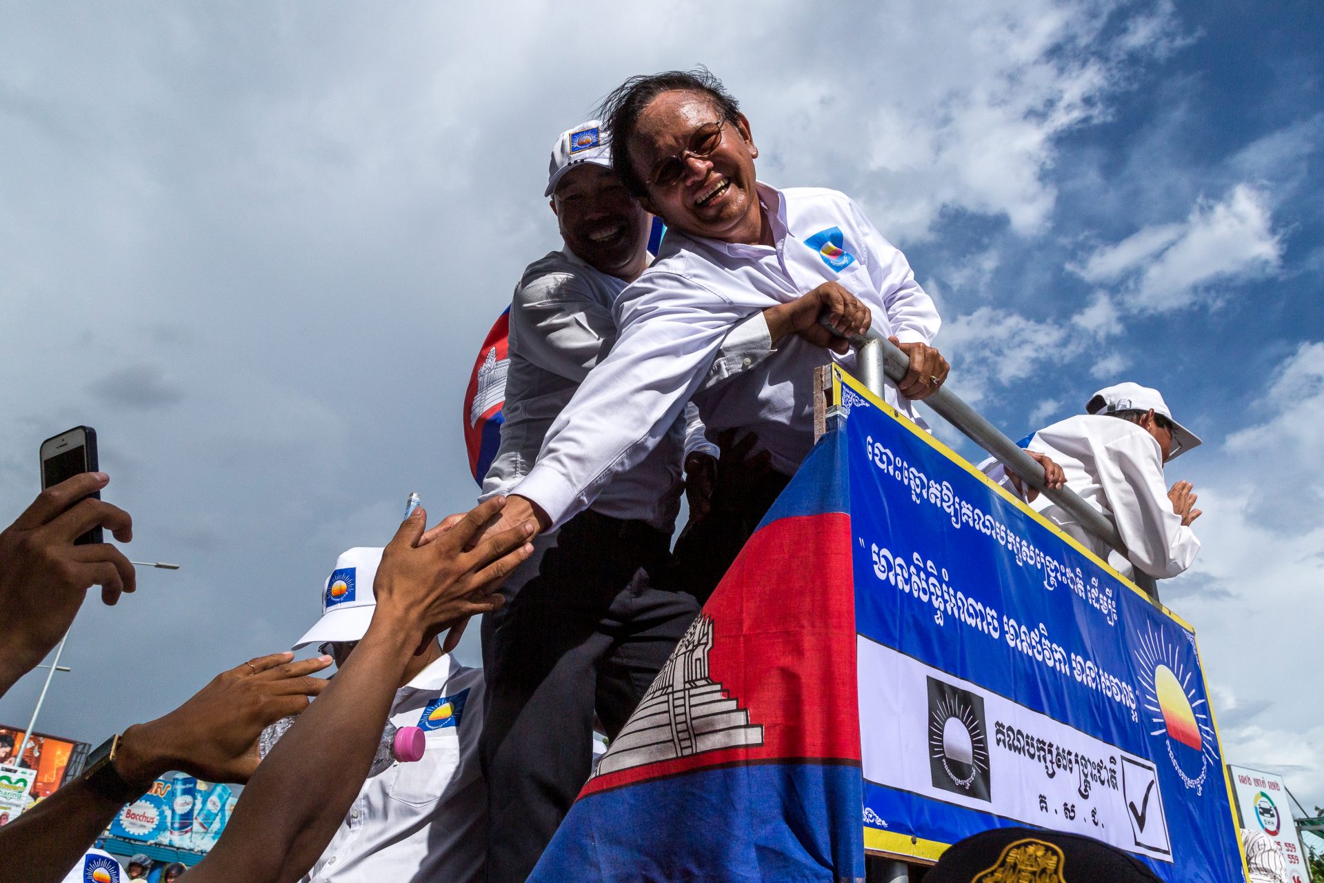 Kem Sokha, the president of the opposition Cambodia National Rescue Party, shakes the hand of a supporter in Cambodia