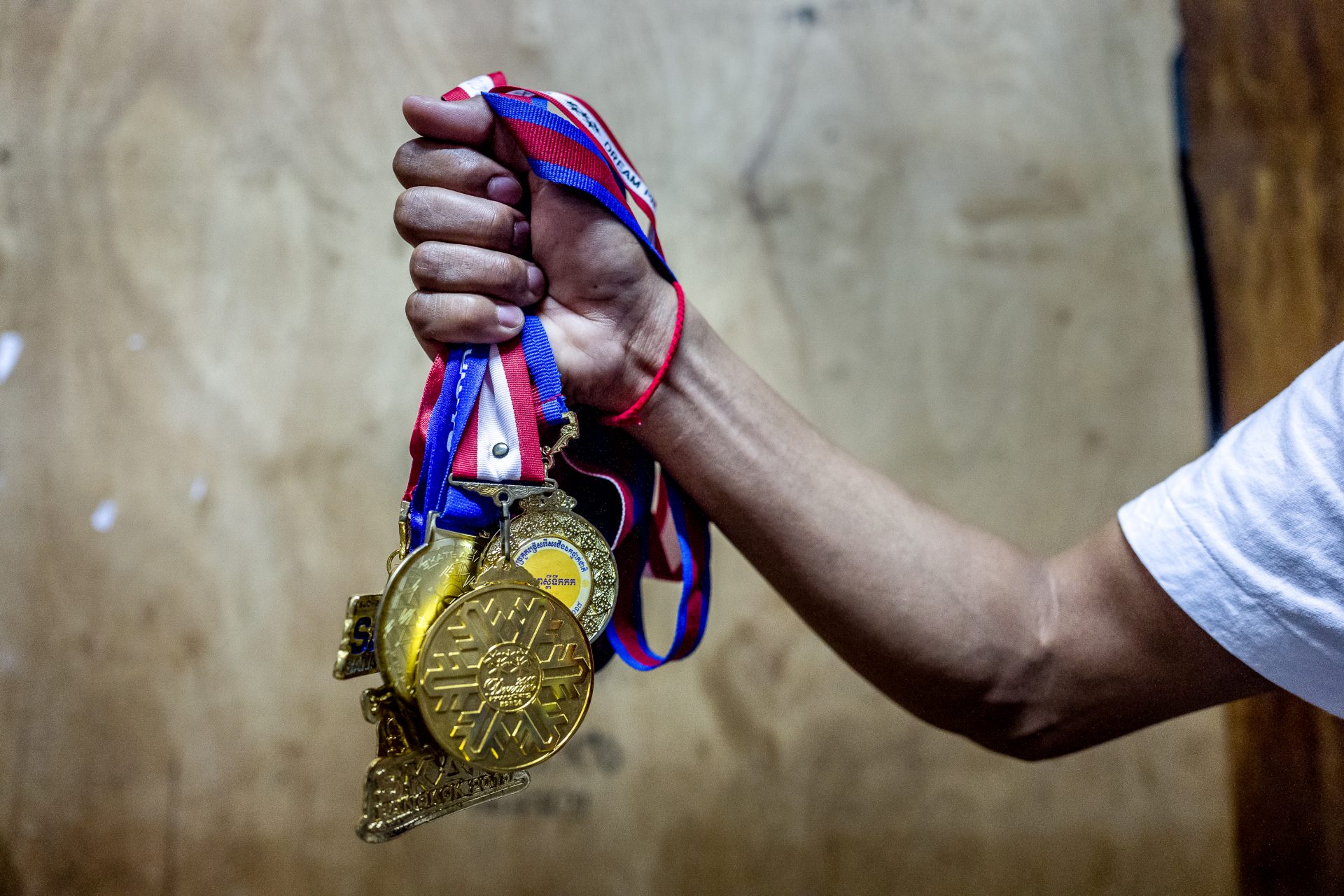 27-year-old skater Sen Bunthoeurn holds all the medals that he has won in skating competitions in Cambodia