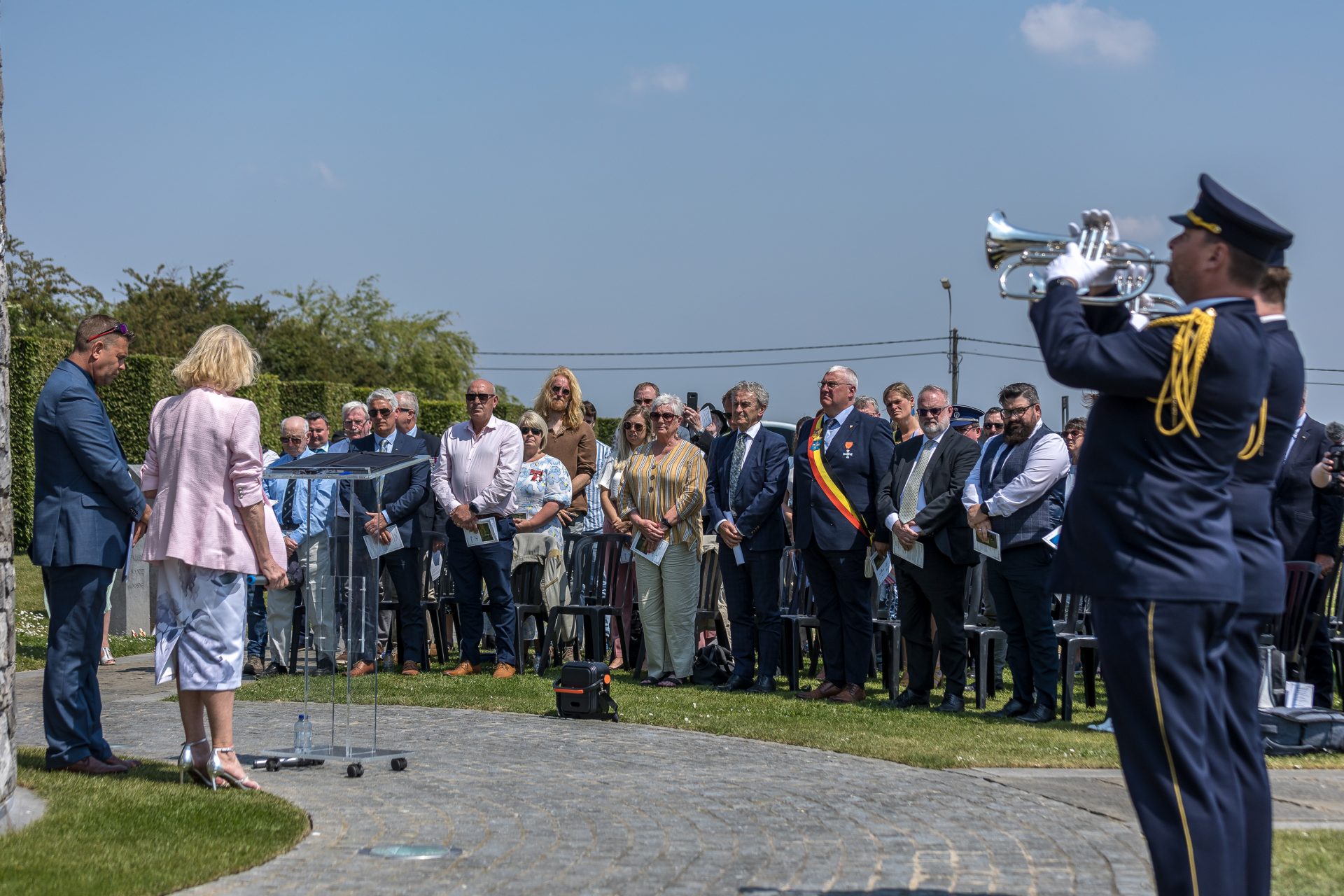 Attendees including The Bourgmestre (Mayor) of Messines, Sandy Evrard, and Paddy Harte, Chair of the International Fund for Ireland (IFI) stand for a minute's silence in Belgium